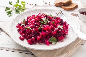 Fresh homemade Beetroot salad Vinaigrette in a white bowl. Traditional Russian food.