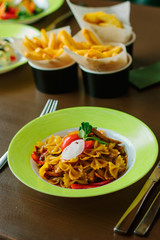 Farfalle pasta in a green plate.
