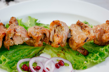 Fresh barbecue meat on white plate.