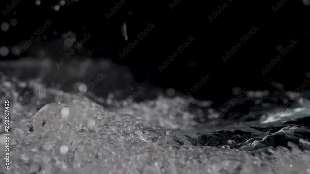 Poster water splashing in slow motion with a dark background
