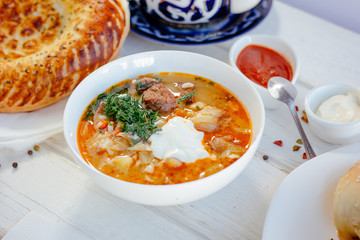 Mastava - uzbek rice soup on white table.