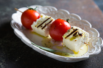 Fried cheese and tomatoes on a skewer