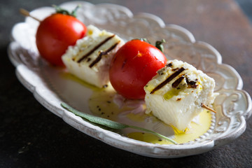 Fried cheese and tomatoes on a skewer