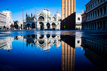 San Marco's square with acqua alta reflect the church in the water with blue sky