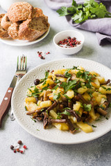 Fried potatoes with mushrooms and fresh herbs.
