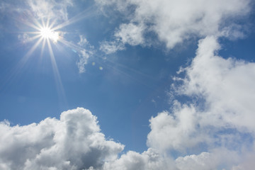 Naklejka na ściany i meble A sunny sky with big clouds as background