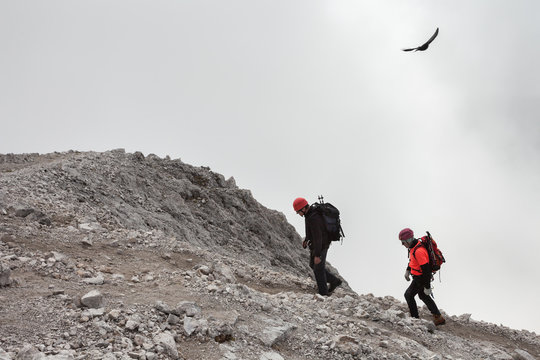 two climbers in a cloudy day few meters above the Sass de Putia peak, a mountain peak in Dolomites