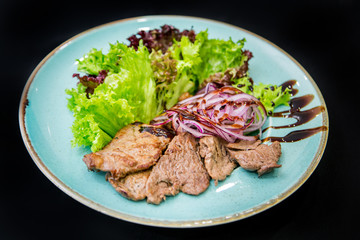 pork with rice and vegetables on white plate