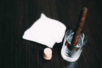 empty the glass after vodka napkin cigar and cork. The end of the meal