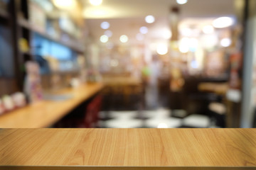 Empty dark wooden table in front of abstract blurred bokeh background of restaurant . can be used for display or montage your products.Mock up for space.