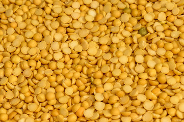 Close up pile of yellow Lentils beans texture, background pattern. Natural grains and cereals. Agricultural product concept. Seamless colorful canvas. Studio shot. Copy space room for text.Top view.