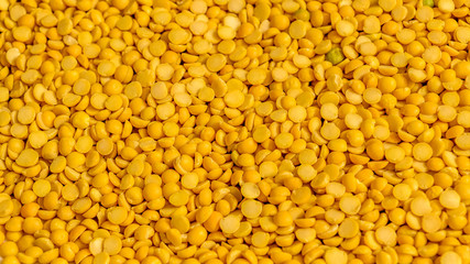 Close up pile of yellow Lentils beans texture, background pattern. Natural grains and cereals....