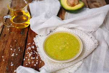 Organic sauce with avocado and oil. Salt. Wooden. Ingridients.