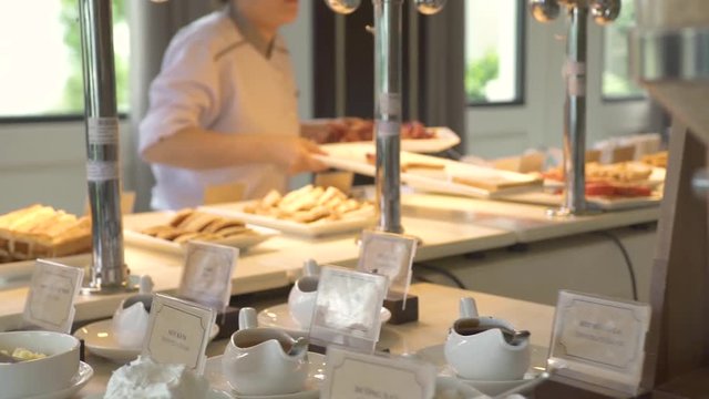 Breakfast buffet table in luxury resort hotel restaurant with assorted food, pastries, sweet cerea and drinks. Food for traditional morning breakfast and brunch in tourist hotel.