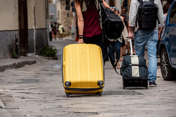 Suitcases with wheels dragged through the streets in the city