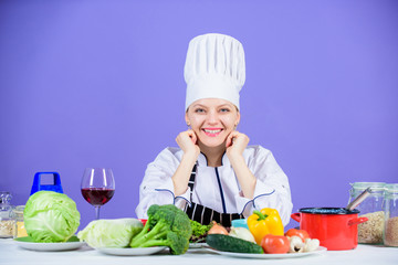 Gourmet cuisine is served here. Happy cook cooking delicious cuisine with vegetarian food. Sexy chef smiling with vegetables for vegetarian cusine. Preparing traditional cuisine for lunch and dinner