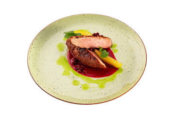 Filet mignon steak served with sauce on a plate isolated at white background.