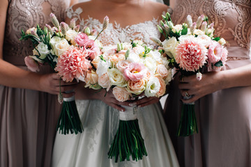 Wedding bouquets in the hands of the bride and bridesmaids 