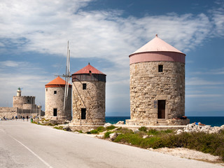 Fototapeta na wymiar The three remaining Windmills located on the wave breaker of Mandraki harbour in Rhodes 