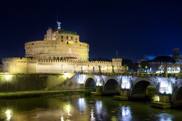 Fototapeta na wymiar View of the bridge and the Angel Castle at night in the illumination over the Tiber River. Rome. Italy.