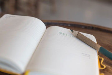 Open diary with pen on wooden table