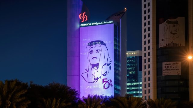 Styalised image of Sheikh Tamim bin Hamad al Thani on the side of a building in central Doha