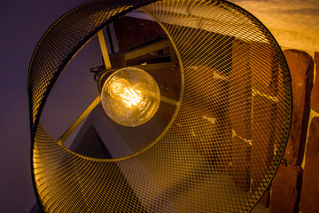 Glow lamp light bulb within the metallic lampshade
