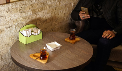 Drink Turkish tea , mobile phone, Waiting