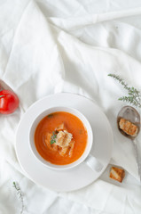 Bowl of  tomato soup on white background.