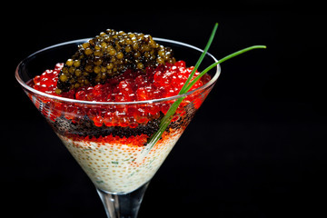 Caviar cocktail in a glass on a black background