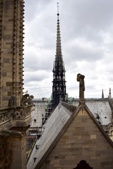 Fototapeta na wymiar Notre Dame Spire, La Fleche, and lead clad wooden roofs before the fire. View of the Apostles, angel statue, chimeras and gargoyles. Paris, France.