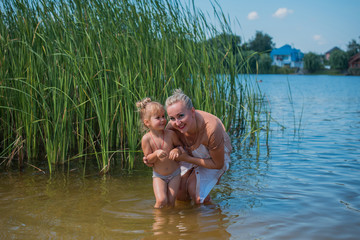 Mom and daughter play at countryside. Happy family walking outdoor on a day time. Concept of...