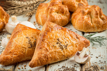 Mushroom pies on wooden table