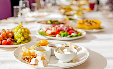 Served tables in restaurants and cafes, meals and drinks on the tables, room design.
