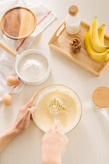 fresh eggs milk and flour on white table