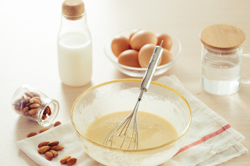 recipe ingredients : eggs, flour, milk, almonds, banana on white background