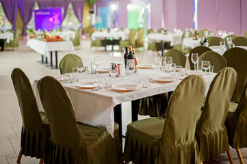 Served tables in restaurants and cafes, meals and drinks on the tables, room design.