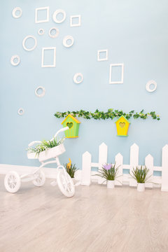 Bicycle against the wall with white picture frames