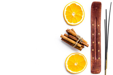 air freshener sticks with cinnamon and orange on white background top view mockup