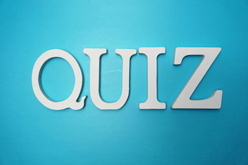 Top view Quiz letters alphabet letters on blue background
