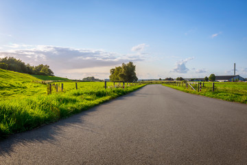 Fototapeta premium path way between fields landscape photo with blue sky 