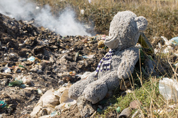 Plastic bags and bottles in a landfill. Unauthorized release of garbage, pollution of nature. The concept of environmental disaster.
