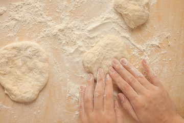 Making dough by female hands at home. Top view