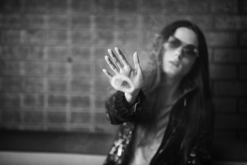Vape teenager with  problem skin. Portrait of young cute girl in sunglasses smoking an electronic...