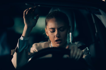 Woman annoyed in car. Girl stuck in traffic.