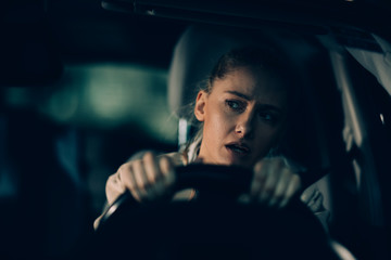 Woman annoyed in car. Girl stuck in traffic.