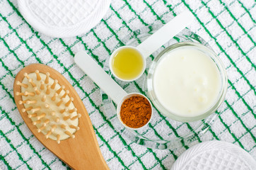 Greek yogurt (sour cream or kefir) facial mask with turmeric powder and olive oil. Ingredients of diy face and hair masks and moisturizers. Homemade beauty treatments recipe. Top view, copy space  