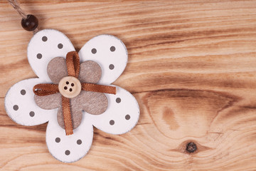 Decorative wooden flower on wooden background