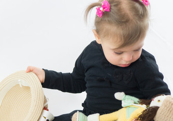 little girl holding hat in hand