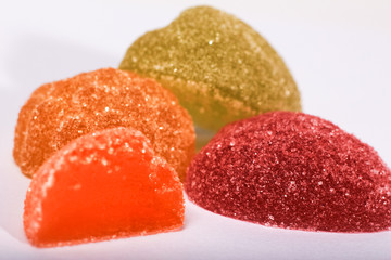 multicolored marmalades on white background